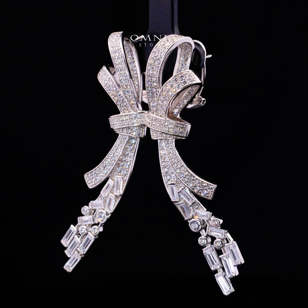 Omnia Celeste Bow Design Earrings in 925 Silver with High-Quality Simulated Diamonds and Elegant Dangling Accents - Image 2